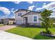 Well-kept lawn and stone accents highlight this two-story home's exterior, with a brick paved driveway at 3134 Viceroy Ct, Poinciana, FL 34759