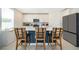 Modern kitchen featuring an island with seating, stainless steel appliances, and sleek white cabinets at 3134 Viceroy Ct, Poinciana, FL 34759