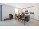 Bright kitchen featuring an island with bar seating, white cabinetry, stainless steel appliances and tile flooring at 3134 Viceroy Ct, Poinciana, FL 34759