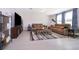 Large living room with tile flooring, leather couches, and a large TV at 3134 Viceroy Ct, Poinciana, FL 34759