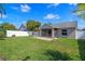 A well-maintained backyard features a screened lanai with plenty of green grass at 3220 Harpers Ferry Ct, Orlando, FL 32837