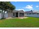 Cozy backyard featuring a screen lanai, green grass, and a gated fence at 3220 Harpers Ferry Ct, Orlando, FL 32837