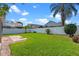 Lush green backyard surrounded by a privacy fence and tropical plants at 3220 Harpers Ferry Ct, Orlando, FL 32837