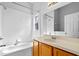 Clean bathroom featuring a tub with tile surround, a window for natural light, and a vanity with a sink at 3220 Harpers Ferry Ct, Orlando, FL 32837