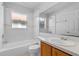 Bright bathroom featuring a tub, toilet, vanity, large mirror and window at 3220 Harpers Ferry Ct, Orlando, FL 32837
