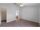 Spacious bedroom with neutral carpet and ceiling fan, offering easy access to a walk-in closet and attached bathroom at 3220 Harpers Ferry Ct, Orlando, FL 32837