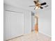 Bedroom with tiled floors, a ceiling fan, closet, and doorway at 3220 Harpers Ferry Ct, Orlando, FL 32837