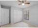 Neutral bedroom featuring a ceiling fan, closet, window, and tiled floor at 3220 Harpers Ferry Ct, Orlando, FL 32837