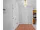 Hallway with tile floors, closet, and entry door with an ornate chandelier in the entry and kitchen view at 3220 Harpers Ferry Ct, Orlando, FL 32837
