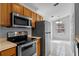 Functional kitchen featuring stainless steel appliances, wood cabinets, and ample counter space at 3220 Harpers Ferry Ct, Orlando, FL 32837