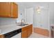 This kitchen is equipped with wood cabinets, stainless steel sink, and ample counter space and adjacent nook at 3220 Harpers Ferry Ct, Orlando, FL 32837