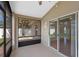 Screened-in lanai with a view of the backyard and a lush green tree at 3220 Harpers Ferry Ct, Orlando, FL 32837