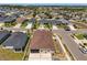 Aerial view of a home in a densely populated neighborhood, featuring a screen enclosed patio and a driveway at 4026 Ruby Run, Haines City, FL 33844