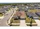 Aerial view of a beige home with a two-car garage on a landscaped lot in a suburban neighborhood at 4026 Ruby Run, Haines City, FL 33844