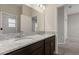 Bathroom with granite countertop, dual sinks, a shower, and updated fixtures at 4026 Ruby Run, Haines City, FL 33844