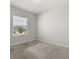 Bedroom with neutral walls and carpet along with a large window at 4026 Ruby Run, Haines City, FL 33844