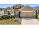 Charming single-story home featuring a well-manicured lawn and a two-car garage at 4026 Ruby Run, Haines City, FL 33844
