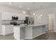 Modern kitchen with stainless steel appliances, white cabinets, and a central island with granite countertops at 4026 Ruby Run, Haines City, FL 33844