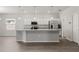 Modern kitchen with stainless steel appliances, white cabinets, and a central island with granite countertops at 4026 Ruby Run, Haines City, FL 33844