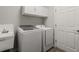 Laundry room with a washer, dryer, sink, cabinets, and white door at 4026 Ruby Run, Haines City, FL 33844