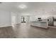 Open-concept living space featuring modern gray walls, and a modern kitchen with stainless steel appliances at 4026 Ruby Run, Haines City, FL 33844