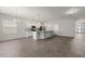 Bright open-concept living space featuring modern gray walls, updated floors, and kitchen with stainless steel appliances at 4026 Ruby Run, Haines City, FL 33844