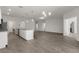 Bright open-concept living space with modern gray walls, updated flooring, and a kitchen with stainless steel appliances at 4026 Ruby Run, Haines City, FL 33844