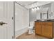 This bathroom features a shower-tub, wooden vanity, decorative mirror, and door to the hallway at 420 Forestway Cir # 108, Altamonte Springs, FL 32701