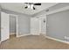 This bedroom features neutral walls, tile floors, and multiple doors to the en suite bathroom and closet at 420 Forestway Cir # 108, Altamonte Springs, FL 32701