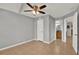 This bedroom features neutral walls, tile floors, and a ceiling fan with attached bathroom at 420 Forestway Cir # 108, Altamonte Springs, FL 32701