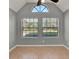 Large room with neutral colors, large windows with blinds, and high ceilings at 420 Forestway Cir # 108, Altamonte Springs, FL 32701