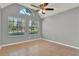 Large bedroom featuring arched window, neutral tones, and ceiling fan at 420 Forestway Cir # 108, Altamonte Springs, FL 32701