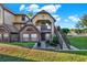 Charming condo featuring a brick facade, balcony, and staircase leading to the entrance at 420 Forestway Cir # 108, Altamonte Springs, FL 32701