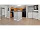 Kitchen, closet with washer/dryer, wood cabinets, black appliances and island at 420 Forestway Cir # 108, Altamonte Springs, FL 32701