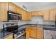 Modern kitchen with stainless steel appliances, granite countertops, and light wood cabinetry at 420 Forestway Cir # 108, Altamonte Springs, FL 32701