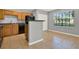 Compact kitchen featuring modern appliances, a breakfast bar, and plenty of cabinet space at 420 Forestway Cir # 108, Altamonte Springs, FL 32701