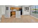 Modern kitchen featuring sleek appliances, laundry, ample cabinet space, and tiled flooring at 420 Forestway Cir # 108, Altamonte Springs, FL 32701