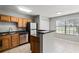 Bright kitchen featuring stainless steel appliances, light wood cabinets, and tile flooring at 420 Forestway Cir # 108, Altamonte Springs, FL 32701