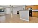 Living area with fireplace and open view to the modern kitchen with wood cabinets at 420 Forestway Cir # 108, Altamonte Springs, FL 32701