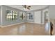 Bright living room with tiled floors, ceiling fan, and large windows offering abundant natural light at 420 Forestway Cir # 108, Altamonte Springs, FL 32701