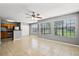 Sunlit living area with tile floors, two large windows and views into the kitchen at 420 Forestway Cir # 108, Altamonte Springs, FL 32701