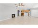 Spacious open-concept living area with tile flooring, a fireplace, and a view into the kitchen at 420 Forestway Cir # 108, Altamonte Springs, FL 32701