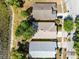 Bird's-eye view capturing homes and the adjacent lake, presenting the property's appealing proximity to water and nature at 4579 Westgrove Way, Orlando, FL 32808
