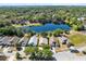 An aerial view features homes nestled in a lush landscape surrounding a peaceful lake, highlighting the community's natural beauty at 4579 Westgrove Way, Orlando, FL 32808