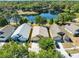 An aerial view of homes near a tranquil lake shows the area's serene setting and the house's desirable location at 4579 Westgrove Way, Orlando, FL 32808