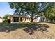 Large backyard with mature trees near the outdoor lanai area at 4579 Westgrove Way, Orlando, FL 32808