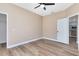 A bedroom offers a modern ceiling fan, wood-look laminate floors, and closet access at 4579 Westgrove Way, Orlando, FL 32808