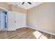 Neutral bedroom with natural light, double closets, and a wood-look floor at 4579 Westgrove Way, Orlando, FL 32808