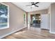Bedroom with wood floors, natural light, and access to the patio at 4579 Westgrove Way, Orlando, FL 32808