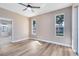 Bedroom with wood flooring, large windows, and a view of the lake at 4579 Westgrove Way, Orlando, FL 32808